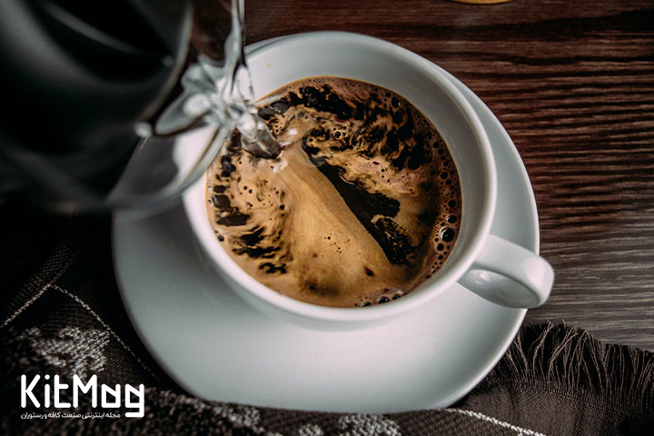 hot water being poured into cup of instant coffee